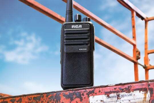 An RDR2500 two-way handheld radio is set on the edge of a construction lift.